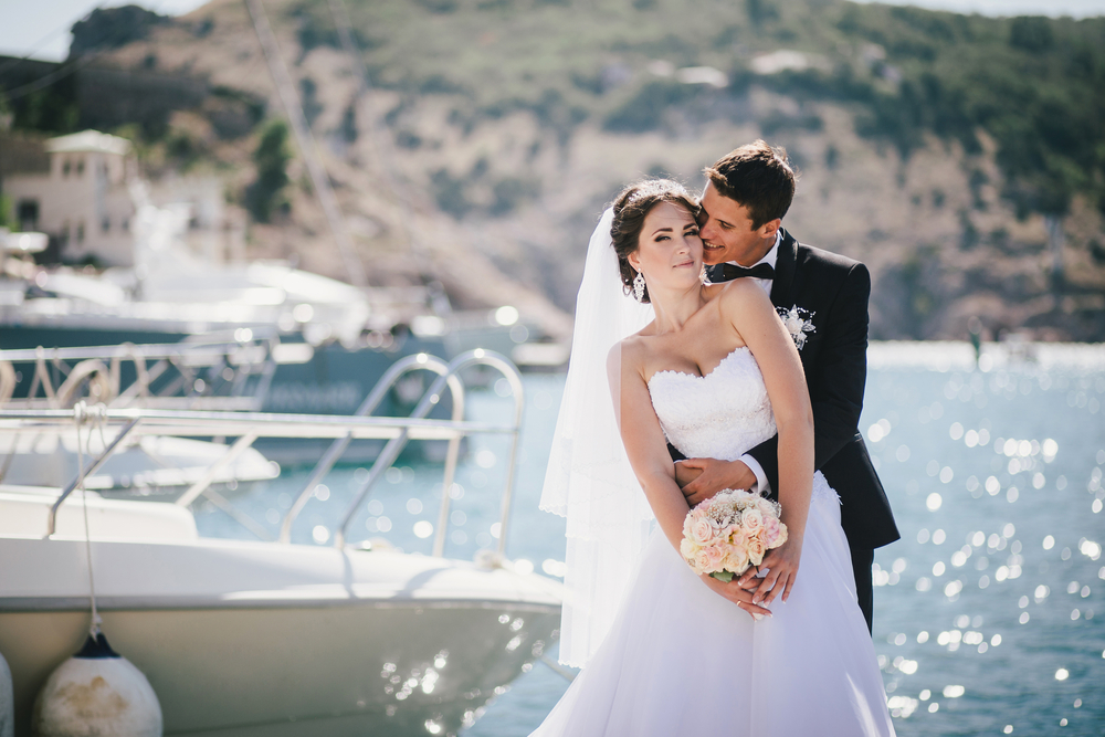 Romantic waterfront wedding showcasing a stunning couple, ideal for destination wedding locations. Featured on Raided by Tintin.