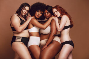 Four diverse women wearing stylish and supportive underwear, showcasing confidence and comfort. Perfect representation for the article 'Good Underwear: Elevating Confidence and Comfort with Style' on Raided by Tintin's website.