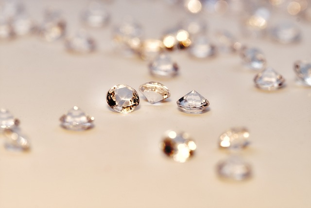 A collection of sparkling lab-made diamonds on a neutral surface, showcasing their brilliance and clarity—featured in Raided by Tintin's article on the truth about lab-grown diamonds.